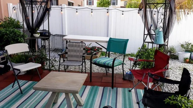 a view of a chairs and table in patio