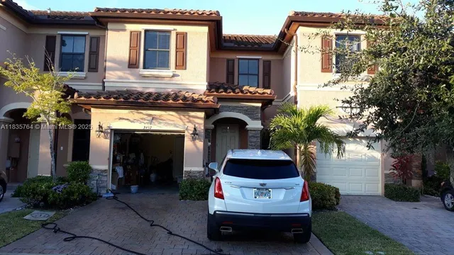 a front view of a house with a garden