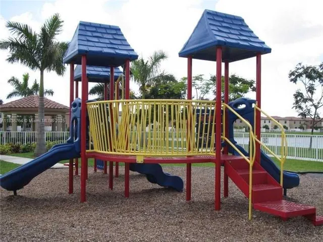 a view of a park with iron fence