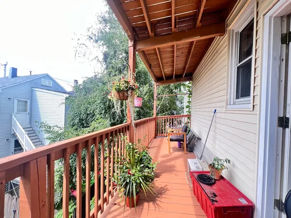 a balcony with furniture and wooden floor