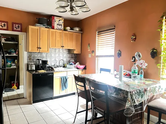 a kitchen with a dining table and chairs