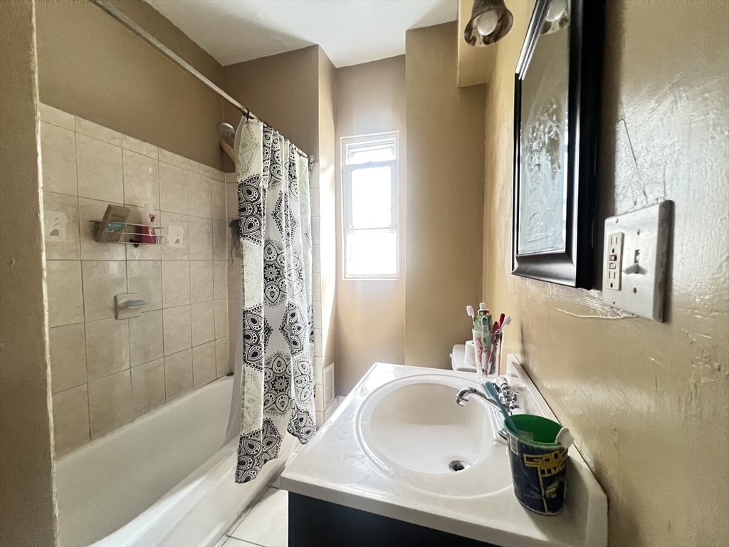 78 Addison Street, Unit B Chelsea, MA 02150 - Photo 7 of 13 a bathroom with a sink and a bathtub