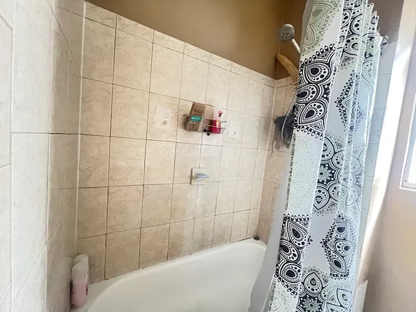 a bathroom with a bathtub and shower