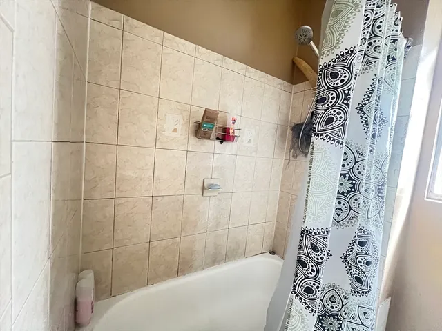 a bathroom with a bathtub and shower