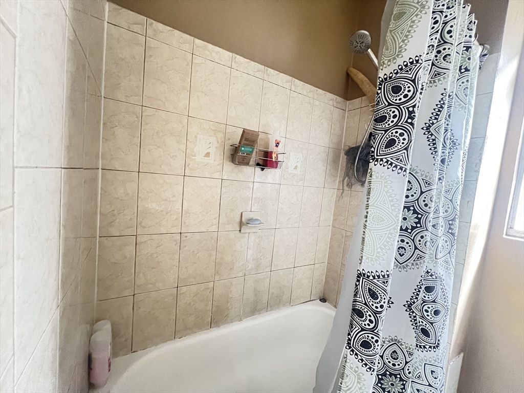 78 Addison Street, Unit B Chelsea, MA 02150 - Photo 8 of 13 a bathroom with a bathtub and shower