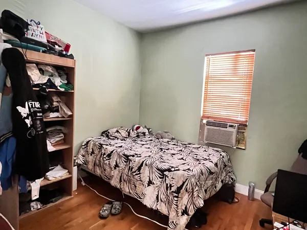 a bedroom with a bed and a window
