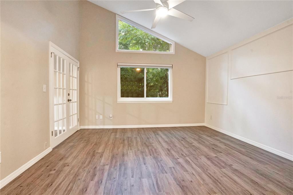 16 Raintree Court Ormond Beach, FL 32174 - Photo 16 of 37 an empty room with wooden floor fan and windows