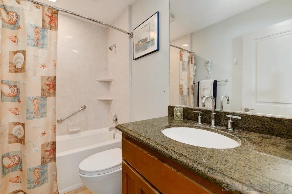 445 E Avenue Coronado, CA 92118 - Photo 13 of 25 a bathroom with a granite countertop sink toilet and shower