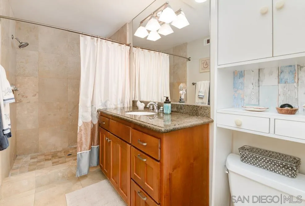 445 E Avenue Coronado, CA 92118 - Photo 10 of 25 a bathroom with a double vanity sink and a mirror