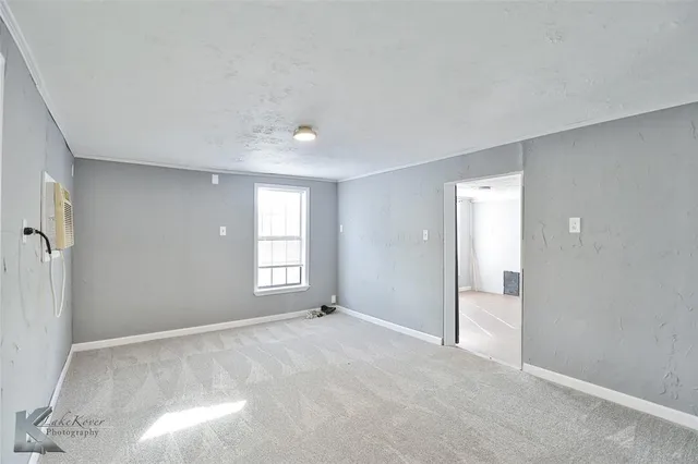 a view of an empty room with a window