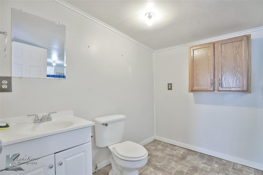 377 Grisham Road Haskell, TX 79521 - Photo 28 of 37 a bathroom with a sink a toilet and a mirror