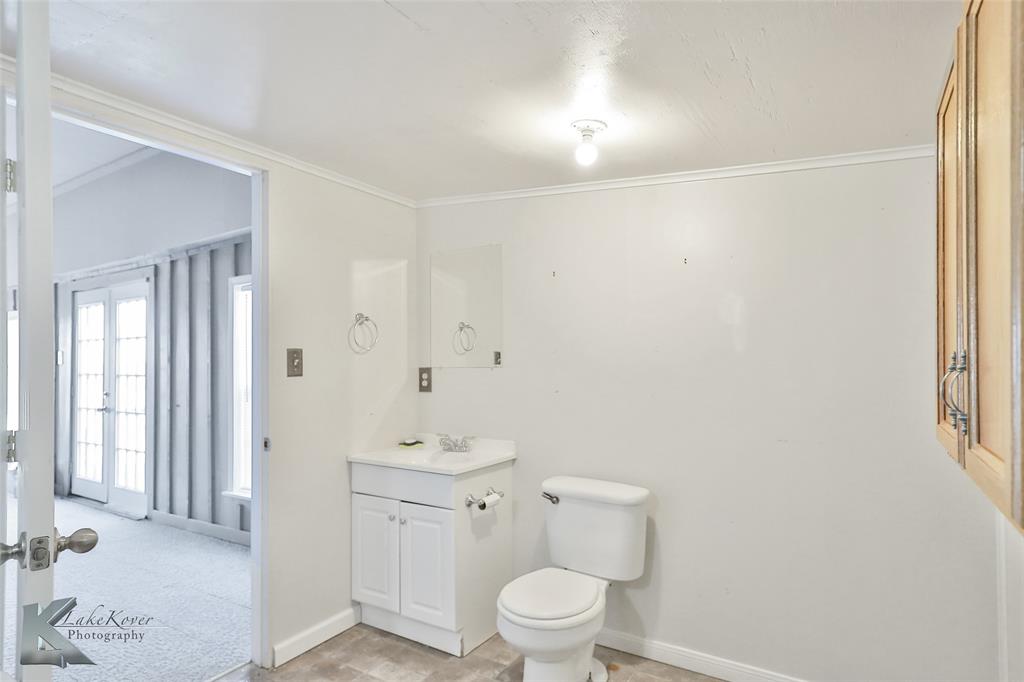 377 Grisham Road Haskell, TX 79521 - Photo 29 of 37 a bathroom with a toilet a sink and a window