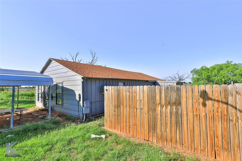 377 Grisham Road Haskell, TX 79521 - Photo 35 of 37 a backyard of a house with lawn chairs and wooden fence