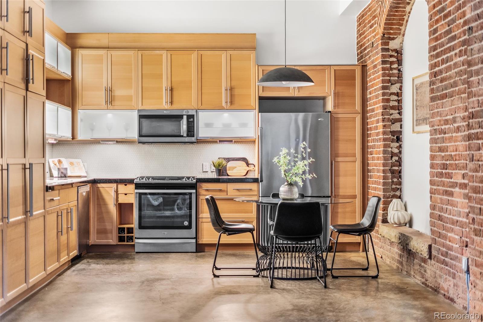 2501 Grove Street, Unit 101 Denver, CO 80211 - Photo 1 of 37 a kitchen with stainless steel appliances kitchen island granite countertop a stove a sink and a microwave