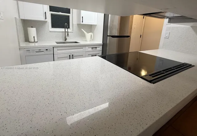a kitchen with stainless steel appliances a refrigerator and a stove