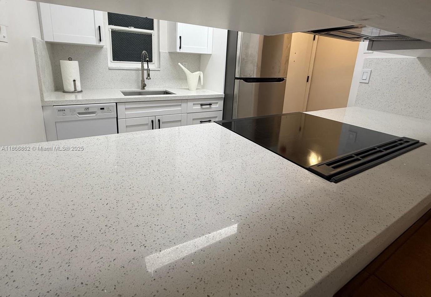 160 Southwest 30th Avenue, Unit 109A Miami, FL 33135 - Photo 4 of 9 a kitchen with stainless steel appliances a refrigerator and a stove