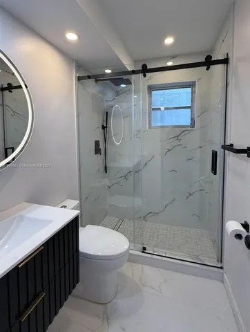 a bathroom with a toilet a sink and shower