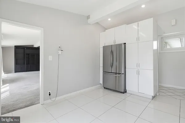 a view of a kitchen with a refrigerator and a sink