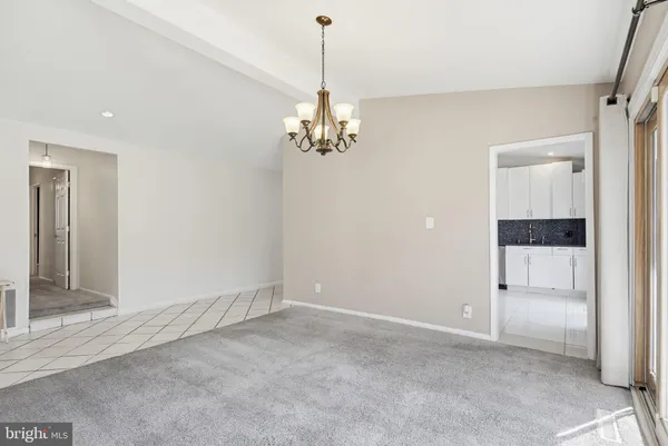 a view of a chandelier in big room and chandelier
