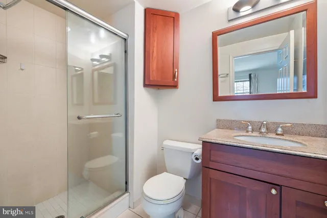 a bathroom with a toilet a sink and mirror