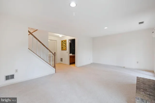 a view of an empty room with stairs