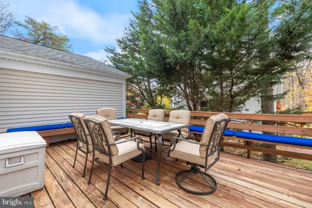 a roof deck with a table and chairs