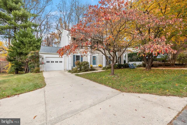 a view of a white house with a yard
