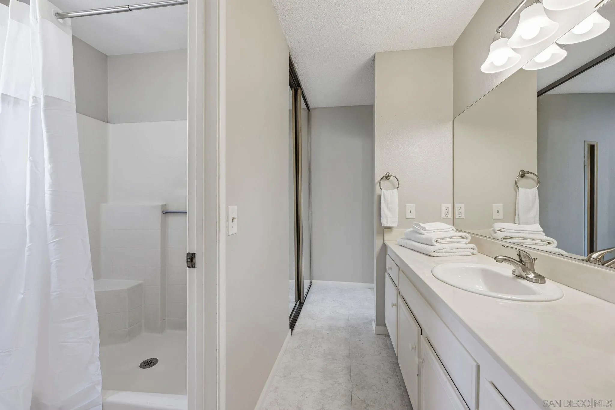 2591 Regent Road Carlsbad, CA 92010 - Photo 21 of 34 a bathroom with a double vanity sink mirror and shower