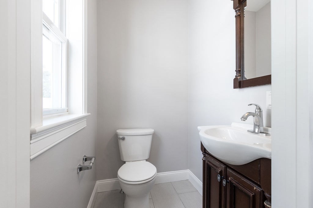 40 Stellman Road, Unit 32 Boston, MA 02131 - Photo 14 of 20 a bathroom with a sink toilet and mirror