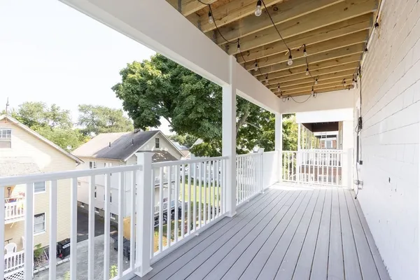 a view of a wooden deck and a yard