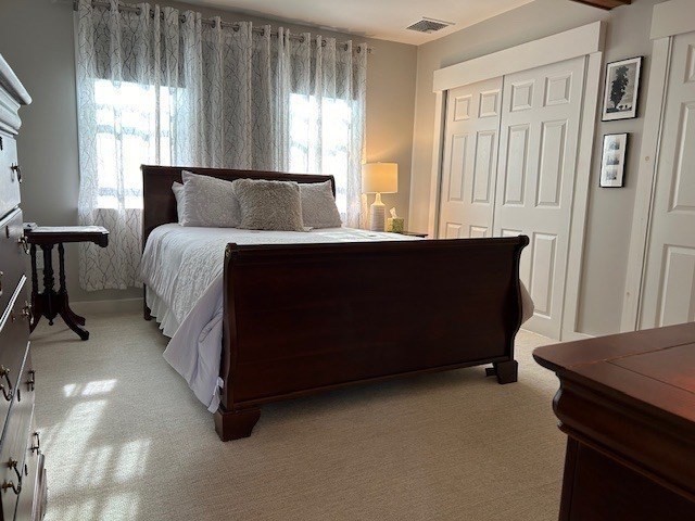 45 Main Street, Unit 221 Wareham, MA 02571 - Photo 14 of 36 a bed sitting in a bedroom next to a window