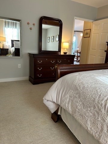 45 Main Street, Unit 221 Wareham, MA 02571 - Photo 15 of 36 a bedroom with a bed and a large mirror on dresser
