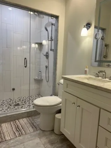 a bathroom with a sink toilet and shower