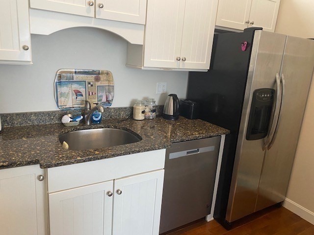 45 Main Street, Unit 221 Wareham, MA 02571 - Photo 21 of 36 a kitchen with stainless steel appliances granite countertop a sink a refrigerator and a granite counter tops