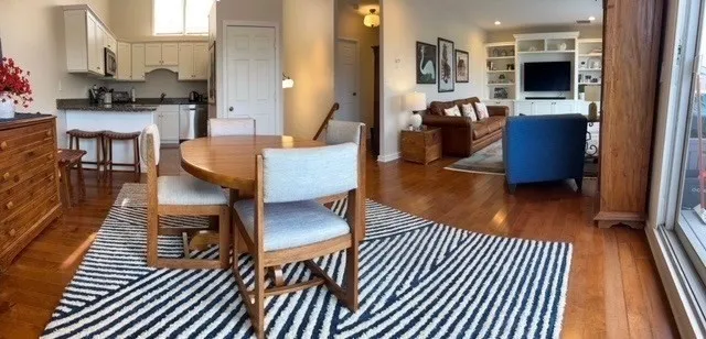 a living room with furniture a flat screen tv and kitchen view