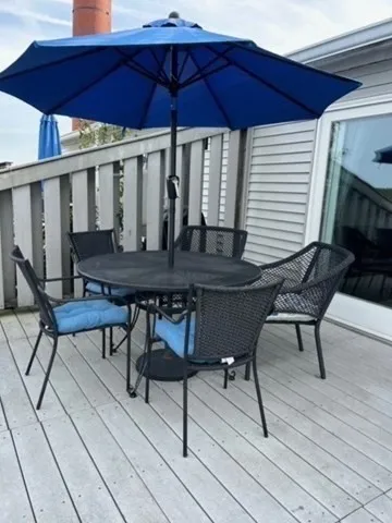 a view of a chairs and table on the deck