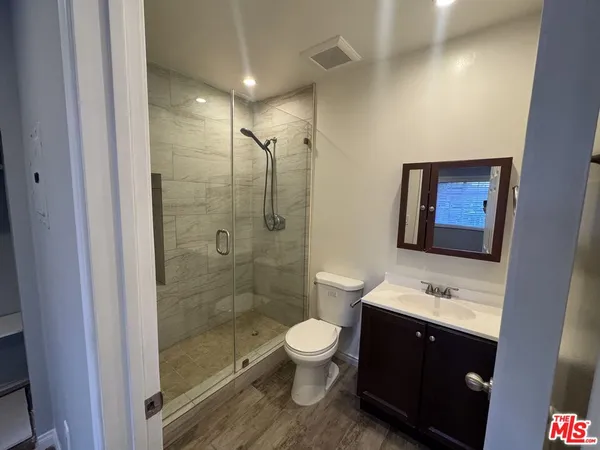 a bathroom with a double vanity sink toilet and shower