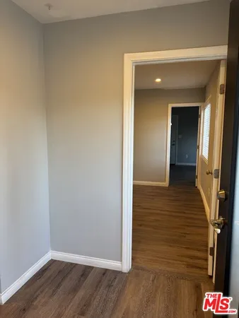 a view of hallway with wooden floor