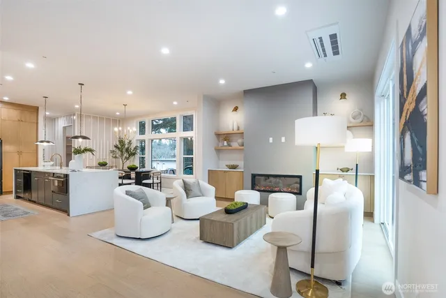a living room with furniture and a view of kitchen