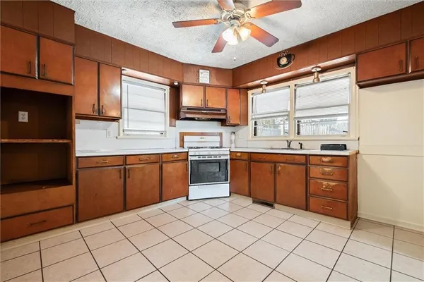 a kitchen with a sink window and cabinets