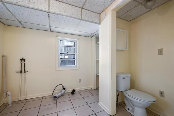 a bathroom with a granite countertop toilet and a shower