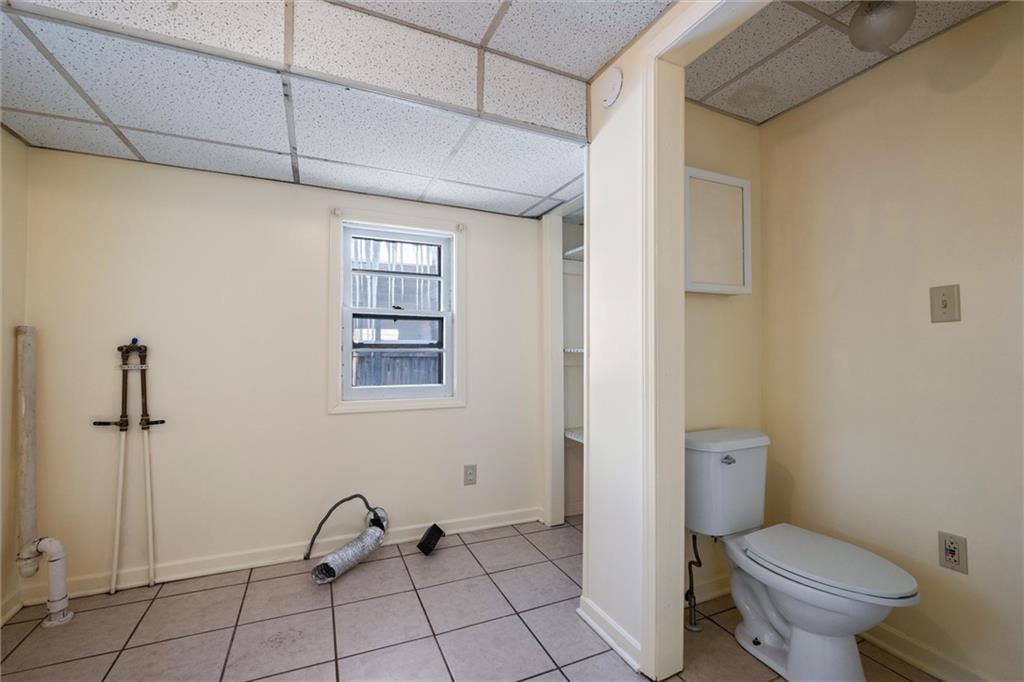 768 Baldwin Avenue Sharon, PA 16146 - Photo 6 of 13 a bathroom with a granite countertop toilet and a shower
