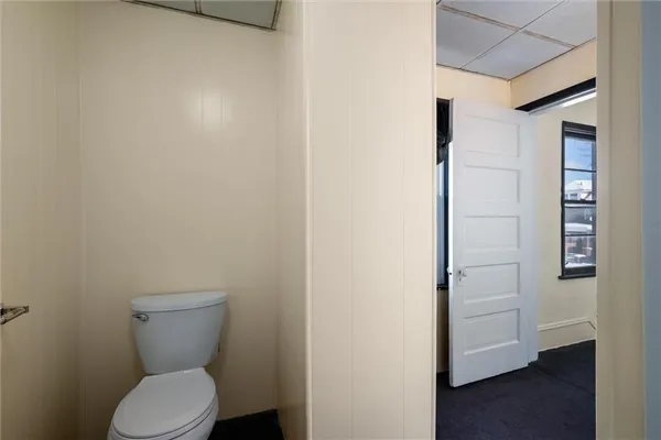 a white toilet sitting next to a shower