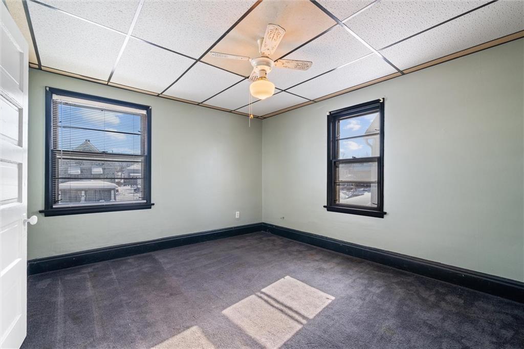 768 Baldwin Avenue Sharon, PA 16146 - Photo 9 of 13 an empty room with windows and ceiling fan
