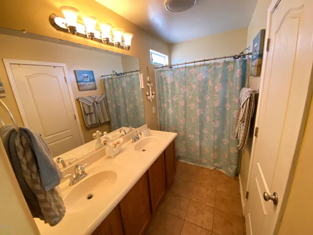 a bathroom with a sink mirror and a shower