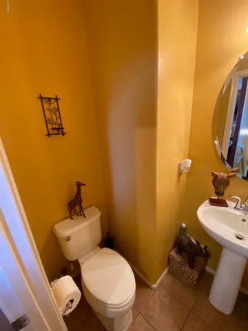 a white toilet sitting next to a bathroom sink