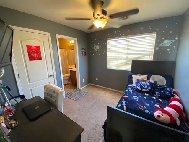 a living room with furniture chess board and a window