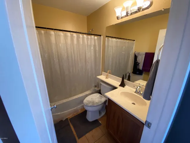 a bathroom with a toilet and a mirror