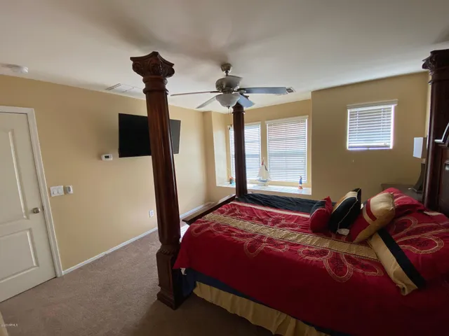 a bedroom with a bed and a chandelier