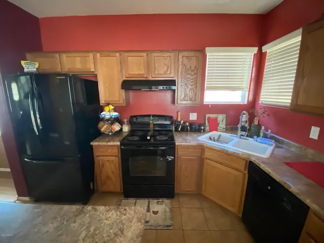 a kitchen with stainless steel appliances granite countertop a refrigerator stove and sink